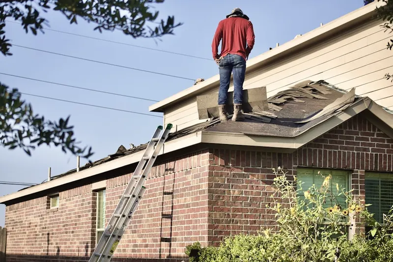 Professional roofer working on a residential roof in Montello